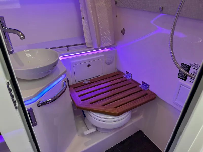 Slide: The Image of 2025 Boston Whaler 380 Realm bathroom with modern fixtures and ambient lighting. - 28