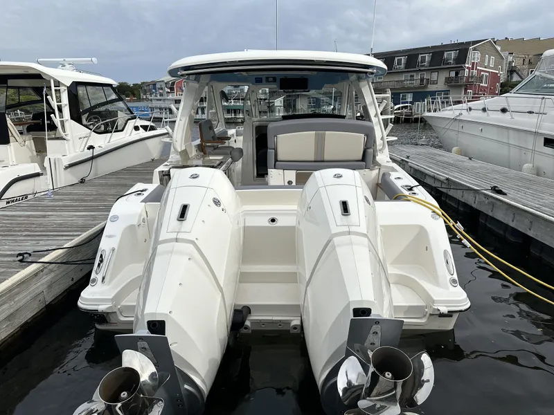 Slide: The Image of 2025 Boston Whaler 380 Realm docked, showcasing dual outboard engines and sleek design. - 3