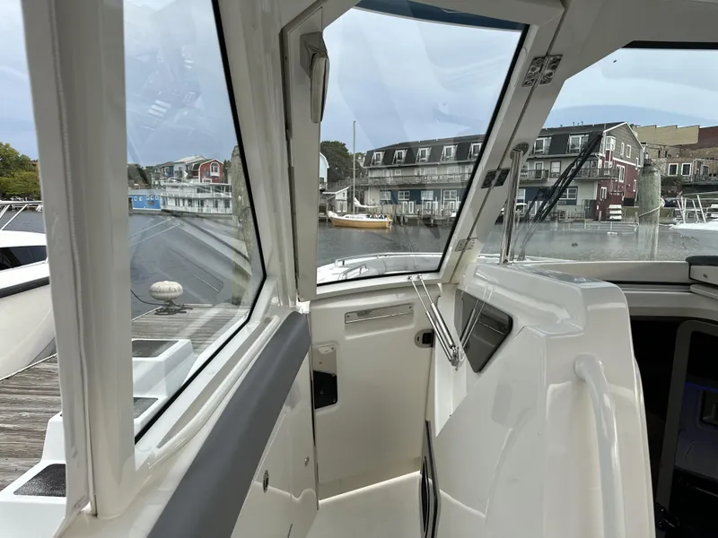 Slide: The Image of Interior view of 2025 Boston Whaler 380 Realm boat docked at marina. - 31