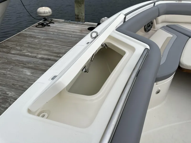 Slide: The Image of 2025 Boston Whaler 380 Realm boat with open storage compartment on deck. - 32