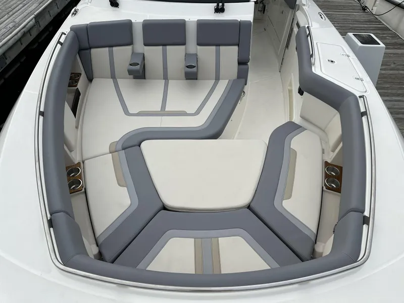Slide: The Image of Luxurious seating area on 2025 Boston Whaler 380 Realm boat, featuring gray and white upholstery. - 35
