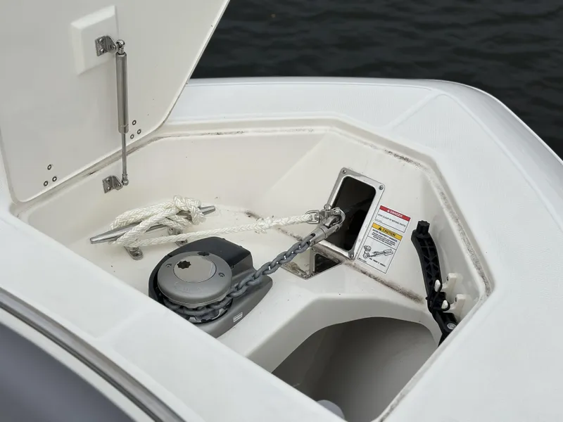 Slide: The Image of 2025 Boston Whaler 380 Realm anchor compartment with chain and rope, open hatch view. - 36