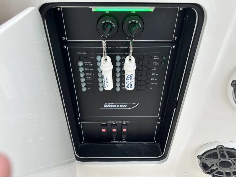 Slide: The Image of Control panel of 2025 Boston Whaler 380 Realm boat with labeled switches and keys. - 41