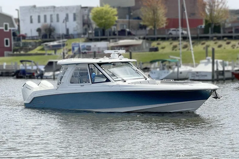 Slide: The Image of 2025 Boston Whaler 380 Realm boat cruising on a calm waterfront. - 43