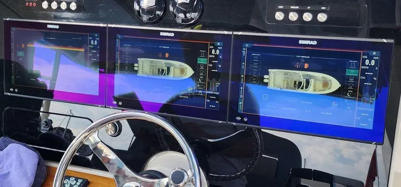 Slide: The Image of 2025 Boston Whaler 380 Realm dashboard with advanced navigation displays. - 5