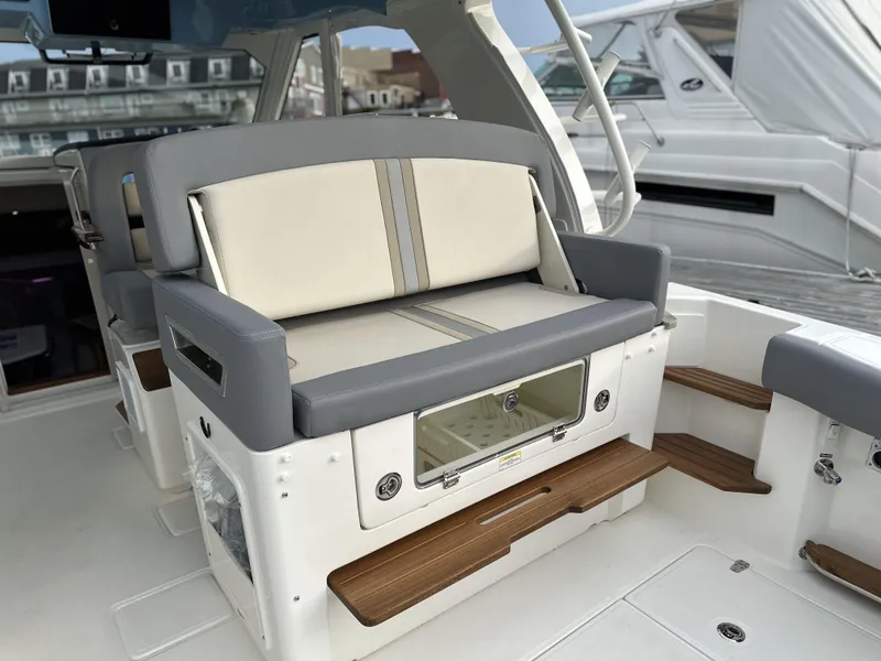 Slide: The Image of 2025 Boston Whaler 380 Realm interior seating with modern design and wooden accents. - 9