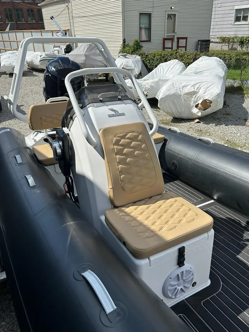 Slide: The Image of 2025 Highfield Sport 460 boat with tan seats and sleek design. - 11