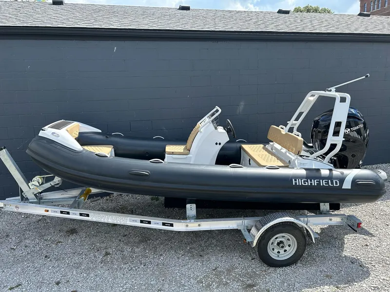 Slide: The Image of 2025 Highfield Sport 460 inflatable boat on trailer, parked outdoors. - 5