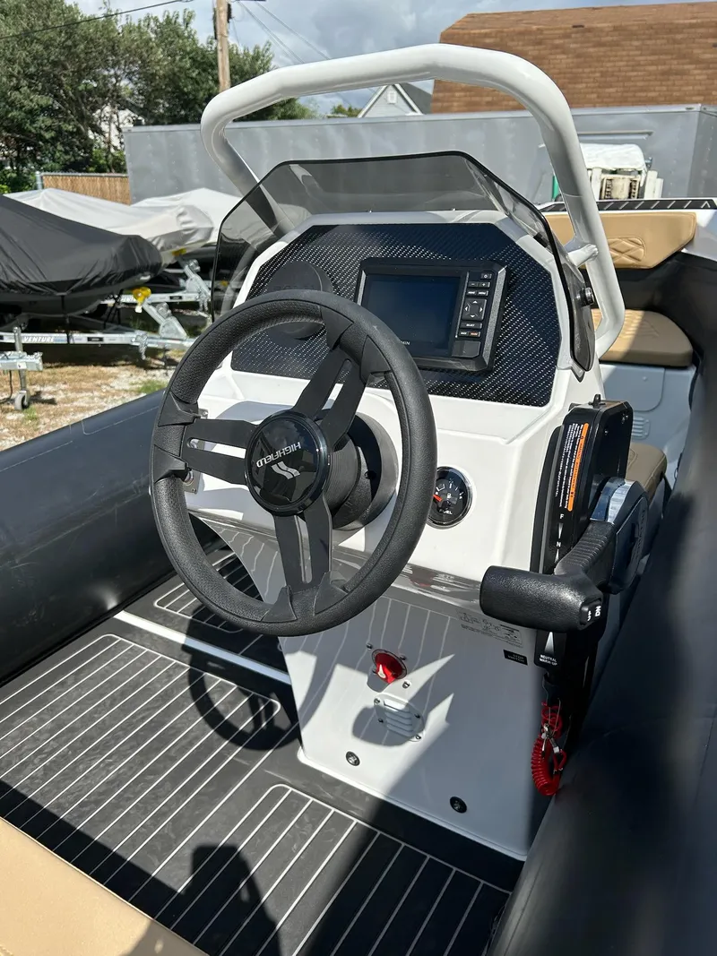 Slide: The Image of 2025 Highfield Sport 460 boat cockpit with steering wheel and control panel. - 6