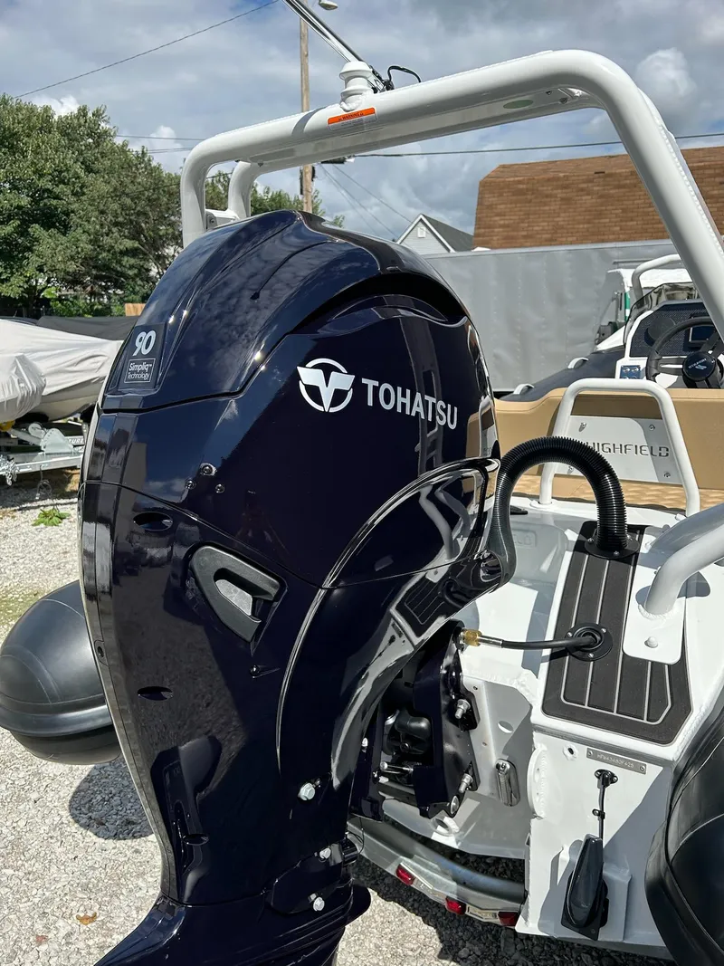 Slide: The Image of 2025 Highfield Sport 460 with Tohatsu outboard motor, parked outdoors. - 8