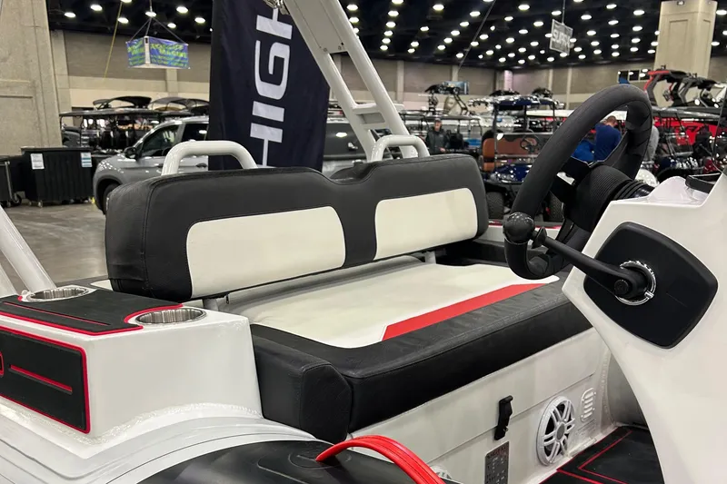 Slide: The Image of 2025 Highfield Velox 420 boat interior with black and white seating at a boat show. - 11