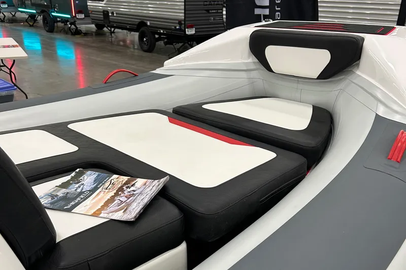 Slide: The Image of 2025 Highfield Velox 420 boat interior with cushioned seating and brochure. - 12