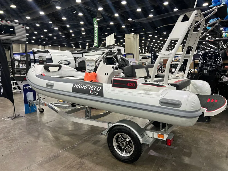 Slide: The Image of 2025 Highfield Velox 420 inflatable boat displayed indoors on a trailer. - 2