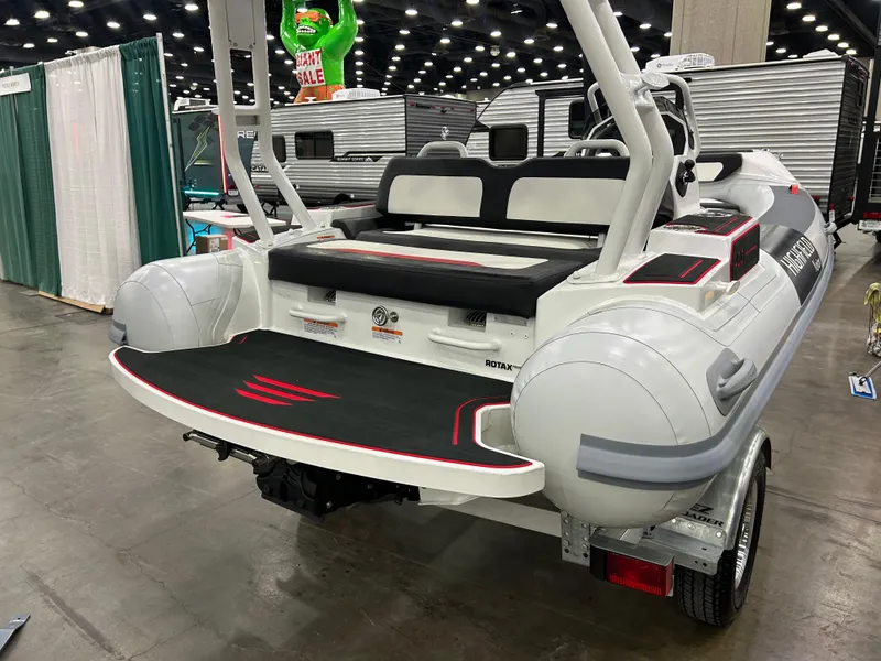 Slide: The Image of 2025 Highfield Velox 420 inflatable boat displayed indoors, showcasing rear seating and design. - 3