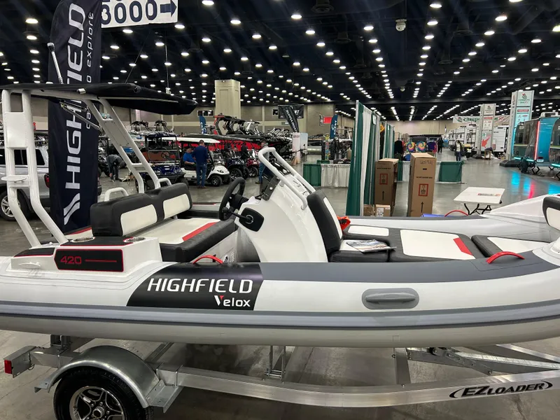 Slide: The Image of 2025 Highfield Velox 420 boat displayed indoors on a trailer. - 7