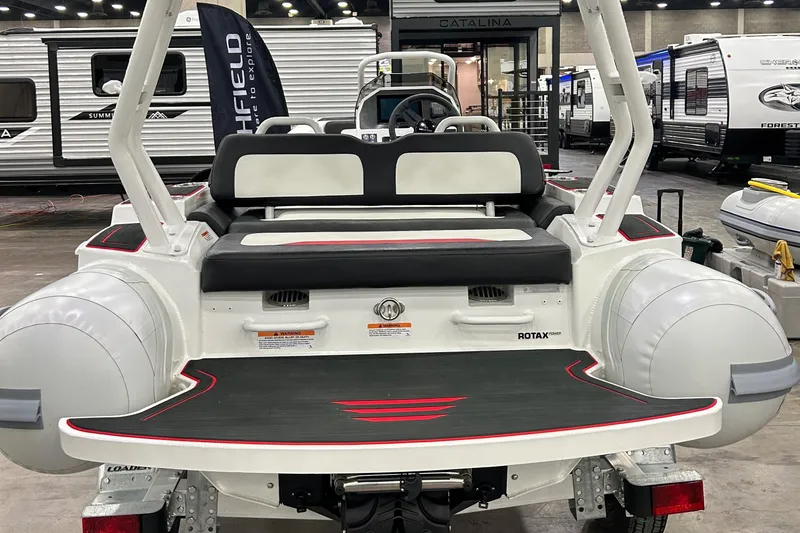 Slide: The Image of Highfield Velox 420 boat, 2025 model, displayed indoors with trailers in the background. - 8