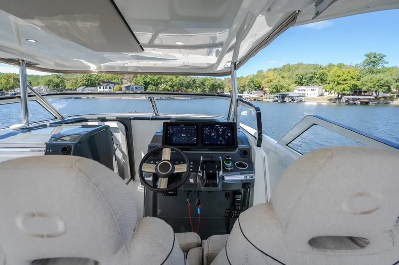 Slide: The Image of Modern 2025 Catamaran YOT 36 cockpit with advanced navigation system on a serene lake. - 31