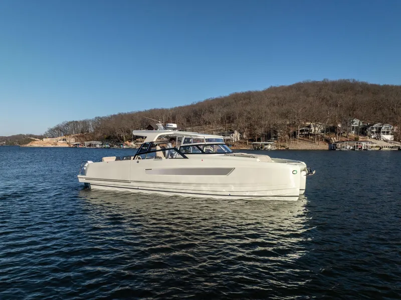 The Image of 2025 Catamaran YOT 36 on a serene lake with wooded shoreline. - 1