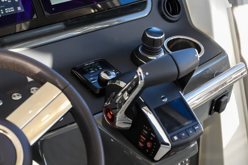 Slide: The Image of Control panel of 2025 Catamaran YOT 36 with modern steering and throttle. - 12