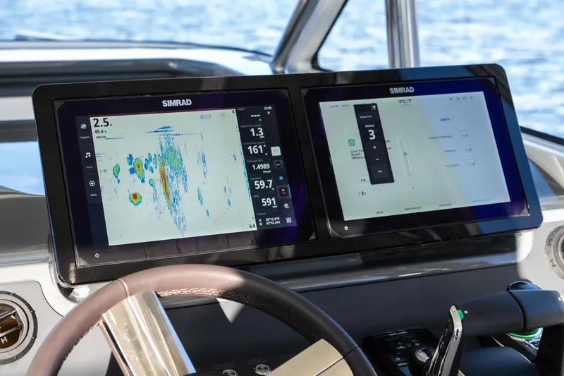 Slide: The Image of Simrad navigation screens on 2025 Catamaran YOT 36, displaying marine data and controls. - 13
