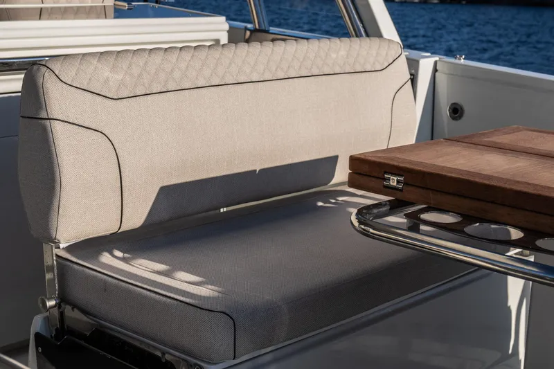 Slide: The Image of Luxurious seating on 2025 Catamaran YOT 36 with elegant upholstery and wooden table. - 19