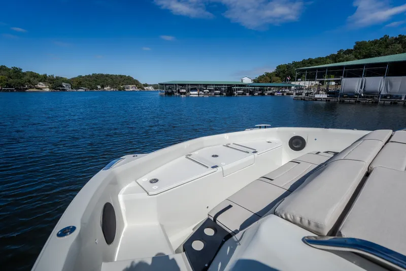 Slide: The Image of 2025 Catamaran YOT 36 on serene lake, featuring spacious seating and modern design. - 57