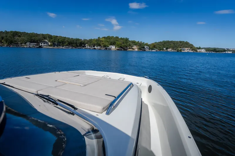Slide: The Image of 2025 Catamaran YOT 36 cruising on a serene lake with clear blue skies. - 62