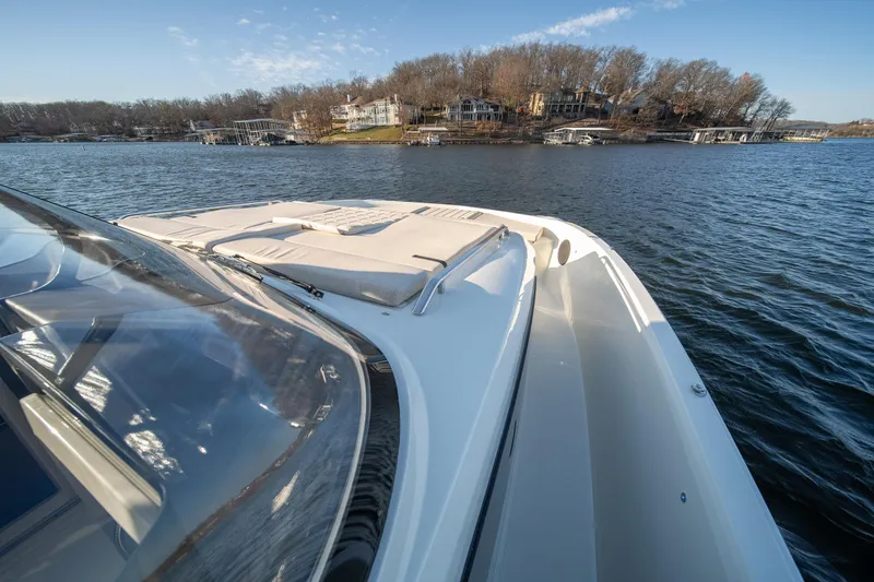 Slide: The Image of 2025 Catamaran YOT 36 on a serene lake with waterfront homes in the background. - 30
