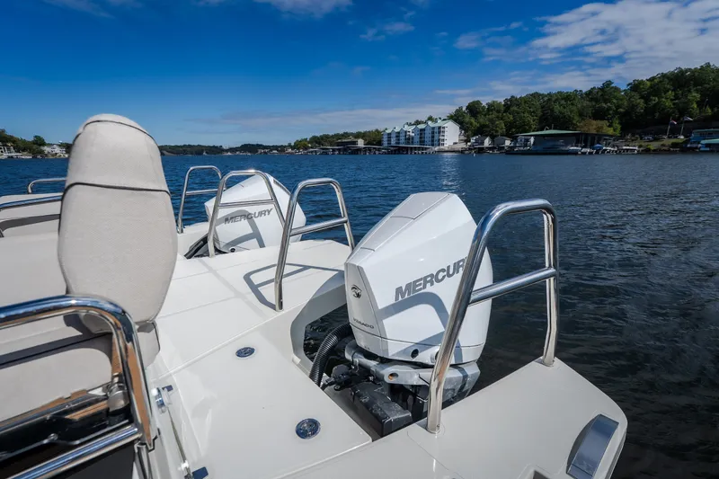 Slide: The Image of 2025 Catamaran YOT 36 with Mercury engines on a serene lake. - 25