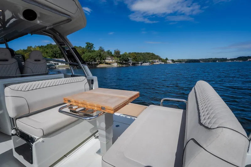 Slide: The Image of Luxurious 2025 Catamaran YOT 36 with elegant seating and scenic lake view. - 27