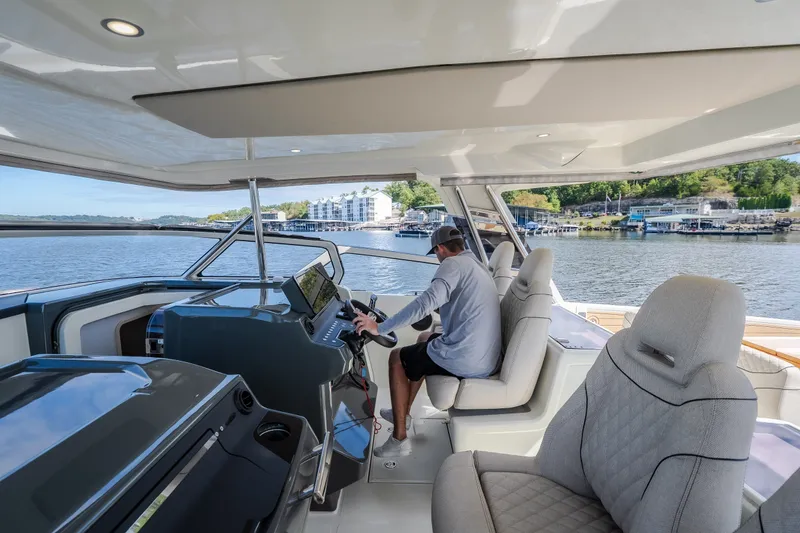 Slide: The Image of Modern 2025 Catamaran YOT 36 interior with captain navigating on a serene waterway. - 71