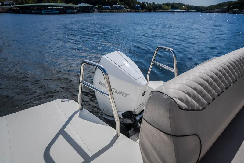 Slide: The Image of 2025 Catamaran YOT 36 with Mercury engine on serene lake backdrop. - 20