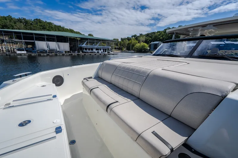 Slide: The Image of Luxurious 2025 Catamaran YOT 36 with spacious seating, docked by a serene waterfront. - 58