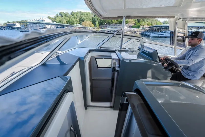 Slide: The Image of Modern 2025 Catamaran YOT 36 interior with driver at helm, docked at marina. - 66