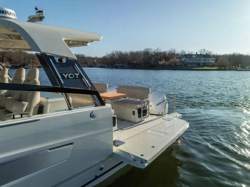 Slide: The Image of 2025 Catamaran YOT 36 on serene lake, showcasing modern design and spacious deck. - 6