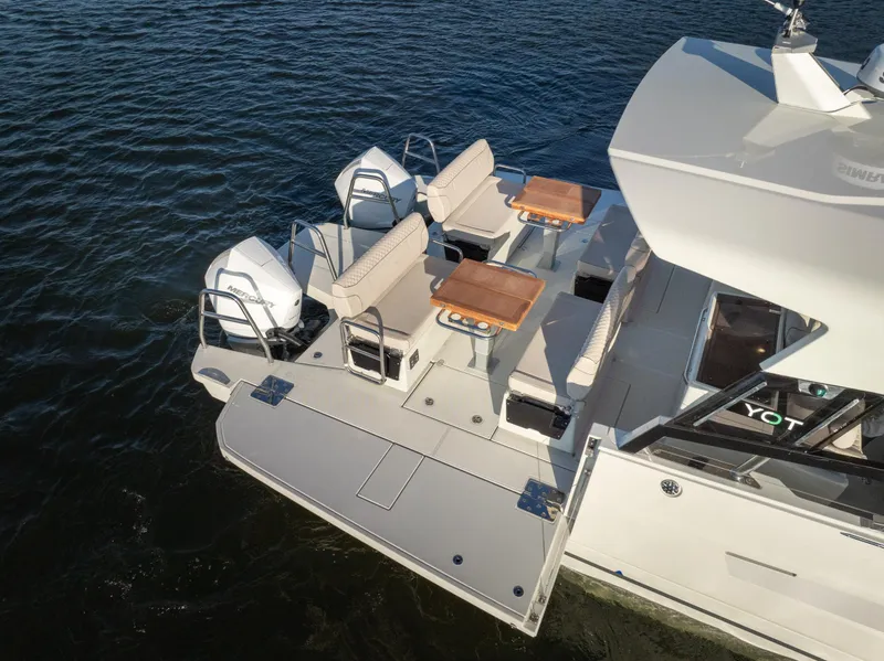 Slide: The Image of 2025 Catamaran YOT 36 with dual engines and seating, cruising on water. - 8