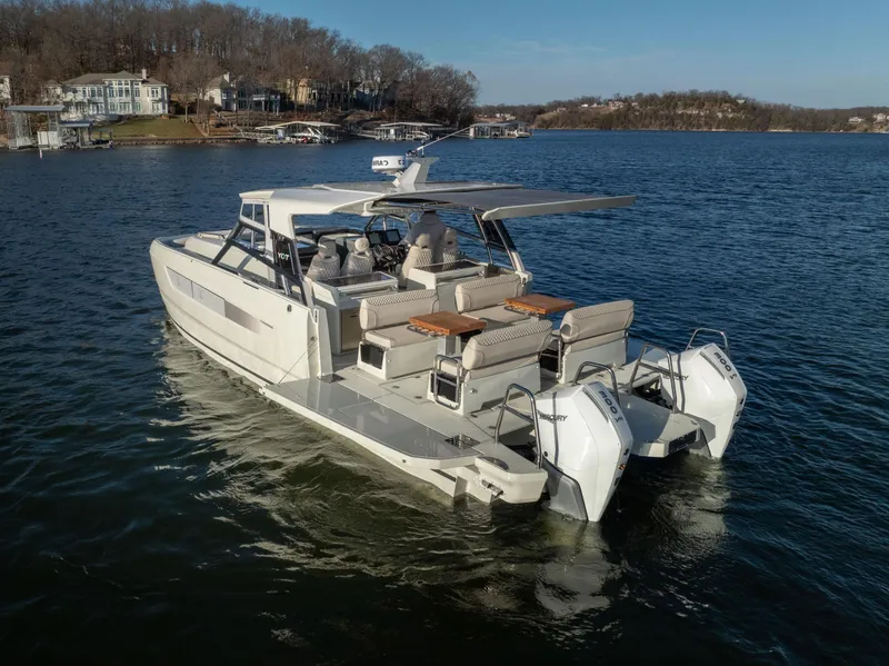 Slide: The Image of 2025 Catamaran YOT 36 cruising on a serene lake with modern design features. - 9