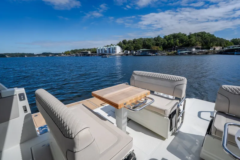 Slide: The Image of Luxurious Catamaran YOT 36, 2025 model, with elegant seating and scenic waterfront view. - 28