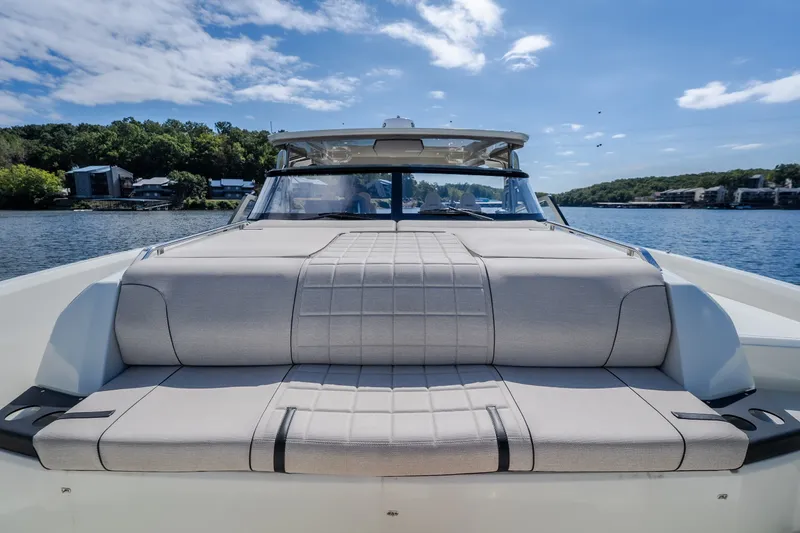 Slide: The Image of 2025 Catamaran YOT 36 on a serene lake, showcasing luxurious seating and modern design. - 59