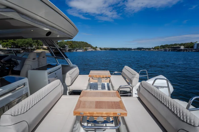 Slide: The Image of Luxurious 2025 Catamaran YOT 36 with spacious seating, cruising on a serene lake. - 24