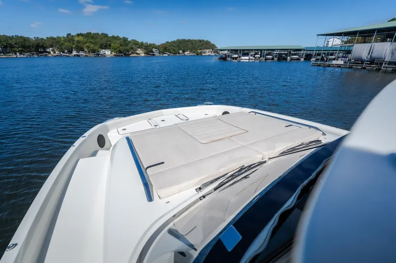 Slide: The Image of 2025 Catamaran YOT 36 on serene lake, featuring spacious deck and modern design. - 56
