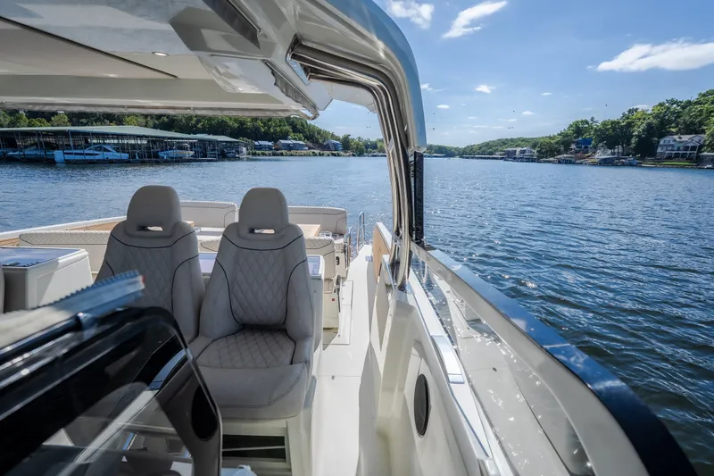 Slide: The Image of 2025 Catamaran YOT 36 on serene lake, featuring luxurious seating and modern design. - 68