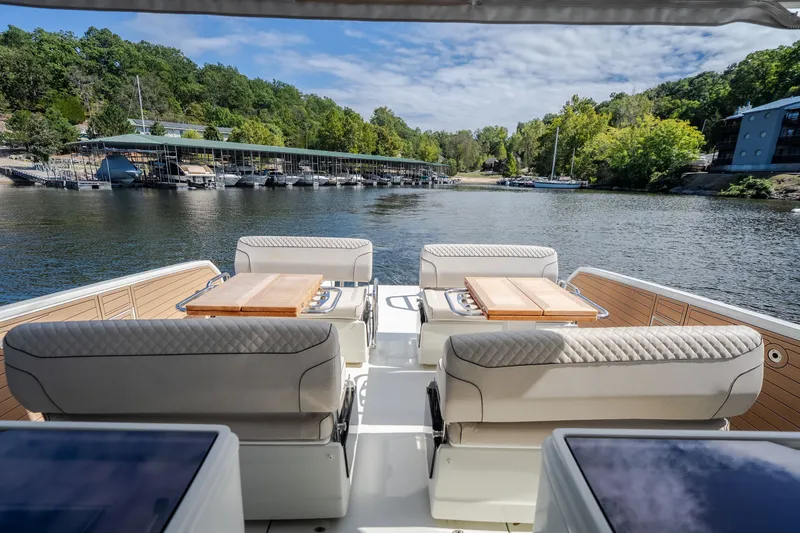 Slide: The Image of Luxurious Catamaran YOT 36, 2025 model, with elegant seating and scenic waterfront view. - 49