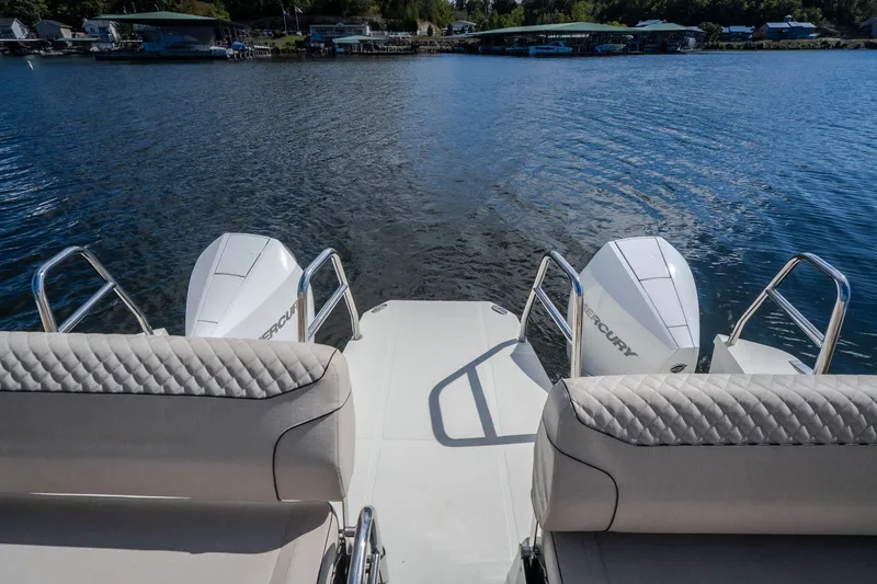 Slide: The Image of 2025 Catamaran YOT 36 with dual Mercury engines on a serene lake. - 19