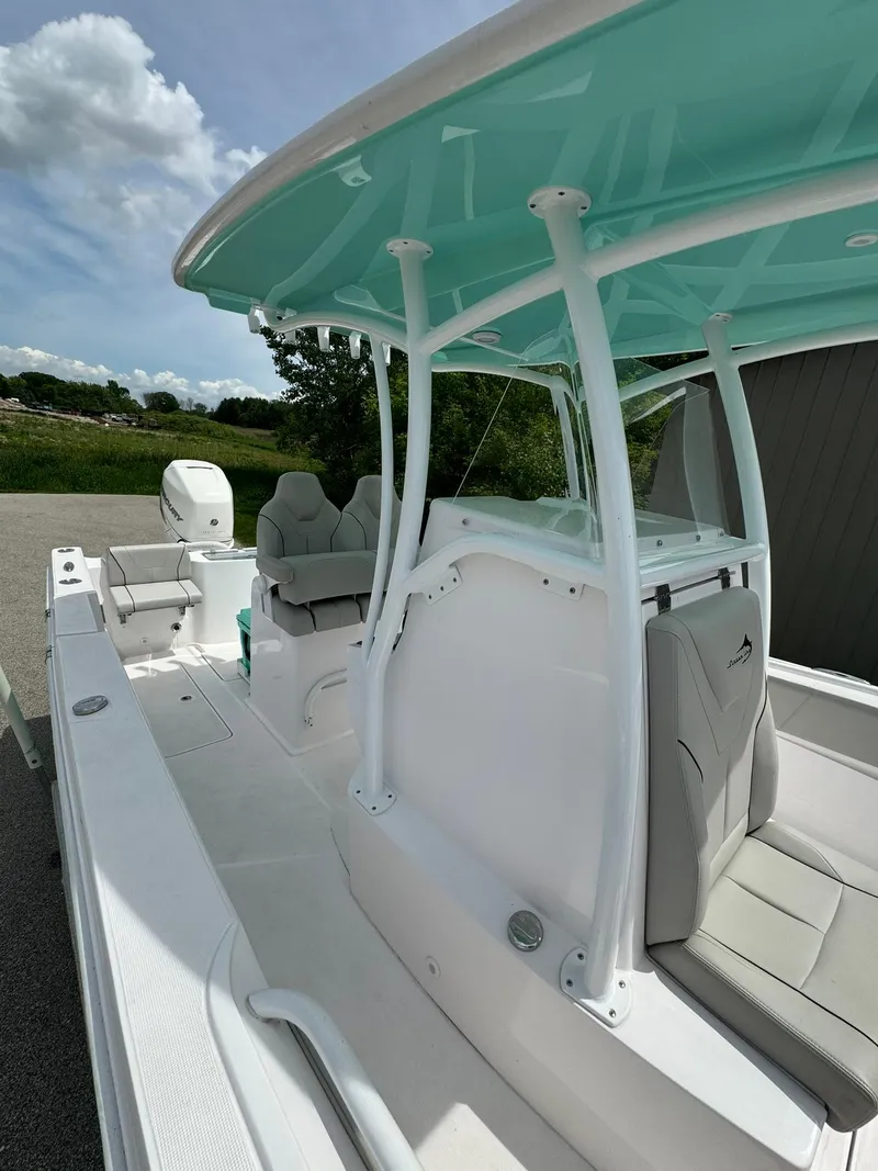 Slide: The Image of 2022 Streamline Center Console boat with teal canopy and sleek design. - 20