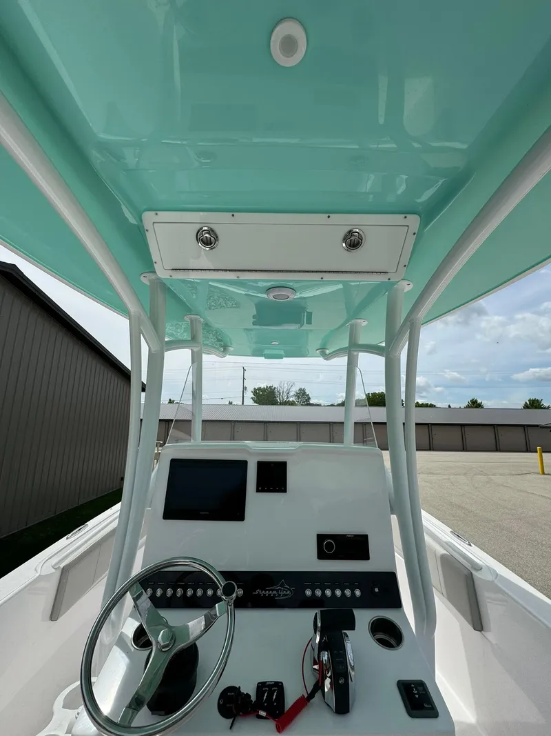 Slide: The Image of 2022 Streamline Center Console boat interior with steering wheel and control panel. - 22
