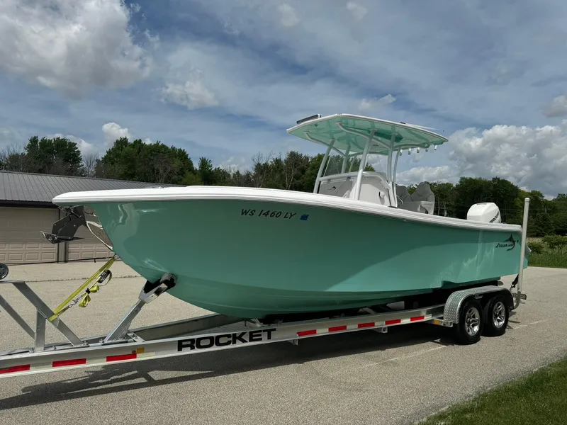 Slide: The Image of 2022 Streamline Center Console boat on trailer under cloudy sky. - 23