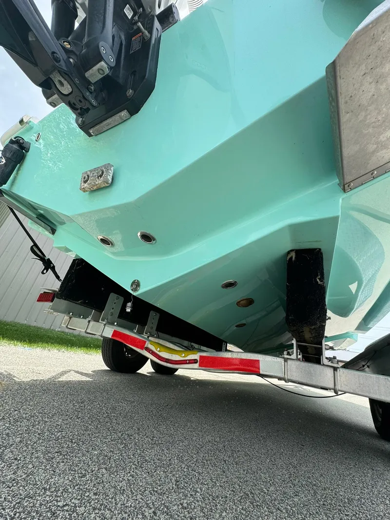 Slide: The Image of 2022 Streamline Center Console boat on trailer, turquoise hull, rear view. - 5