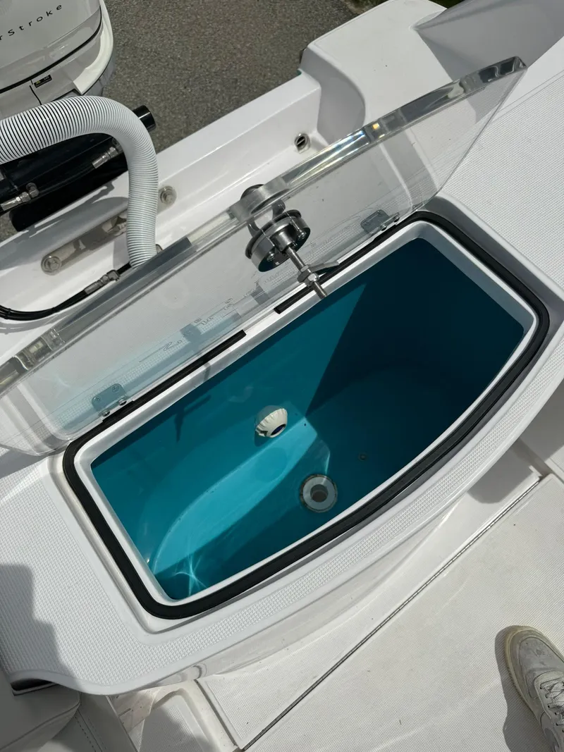 Slide: The Image of 2022 Streamline Center Console boat livewell with open lid and blue interior. - 9