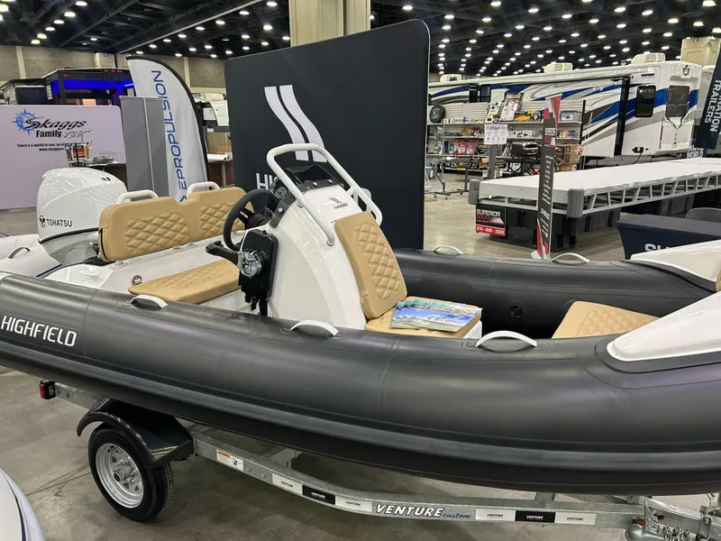 Slide: The Image of 2024 Highfield Sport 390 inflatable boat displayed at an indoor exhibition. - 0